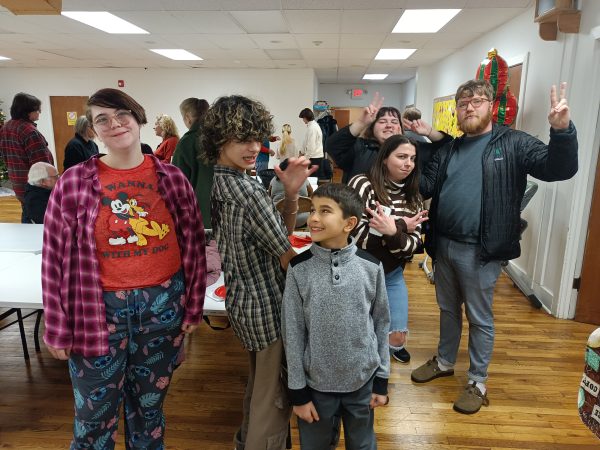 some of our youth and young adults strike silly poses together after a weekend worship gathering